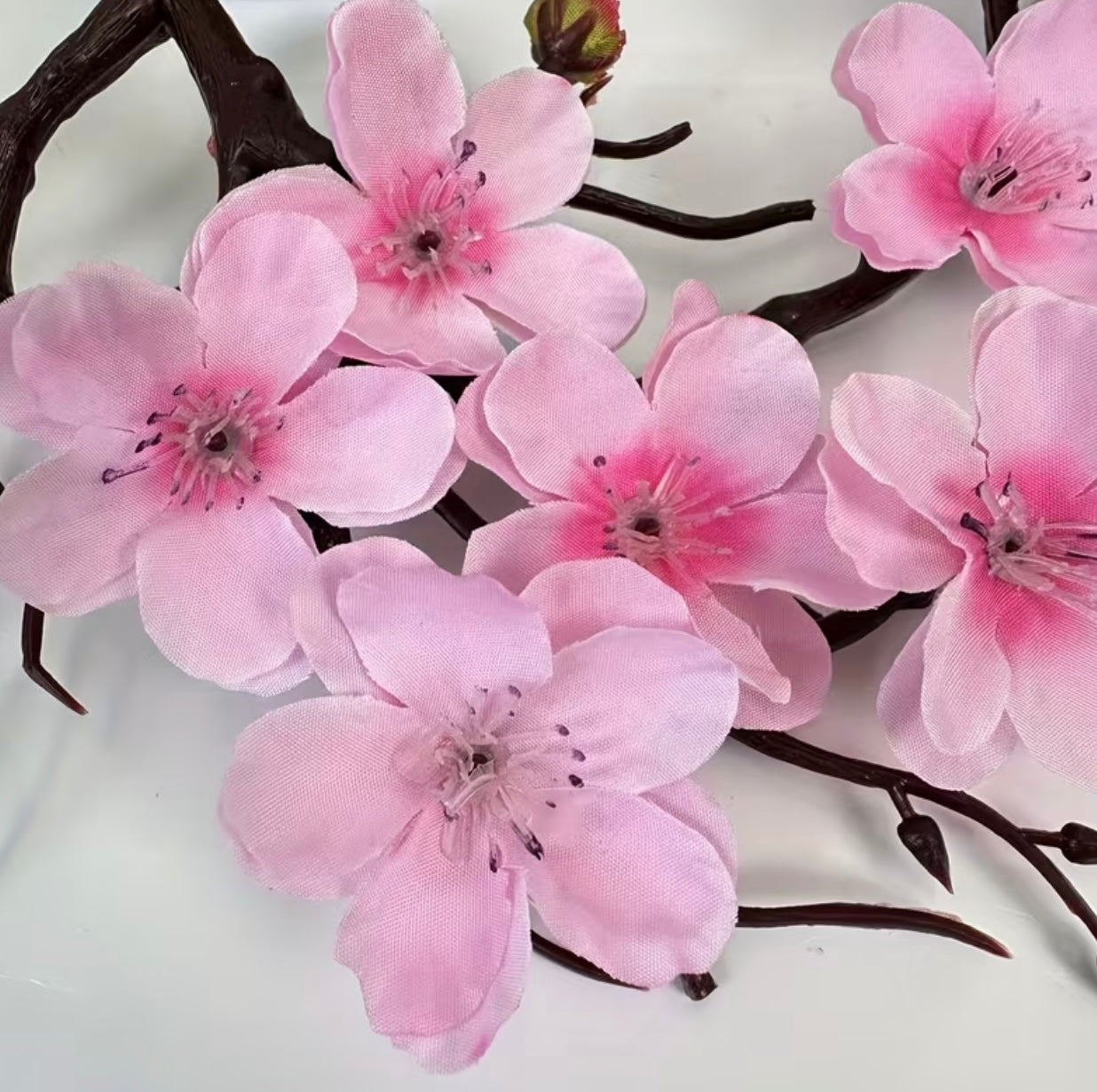 A set of potted plants with artificial plum blossoms
