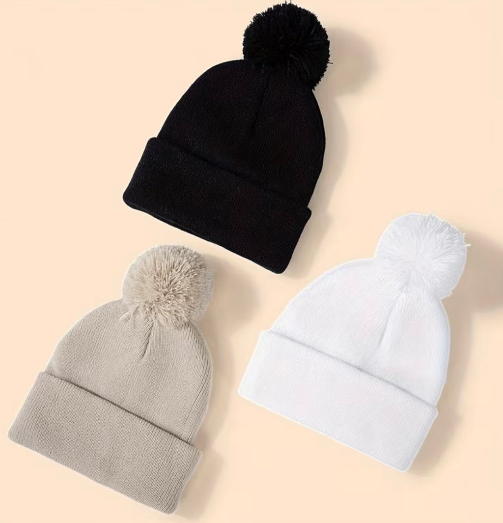 Set of three solid colour hats with women's pompoms