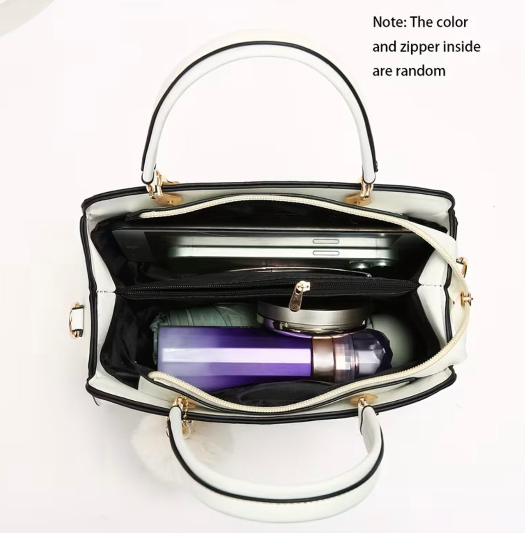 Fashionable handbag with decorative pompom