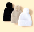 Set of three solid colour hats with women's pompoms