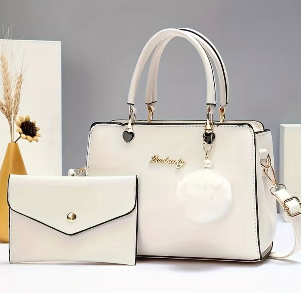 Fashionable handbag with decorative pompom