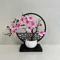 A set of potted plants with artificial plum blossoms