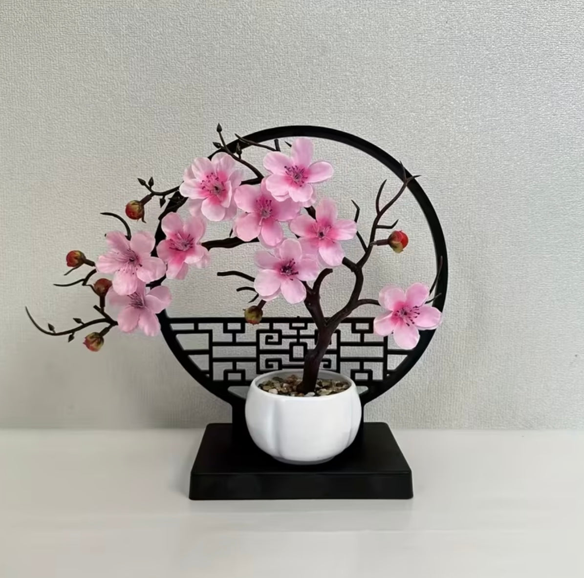 A set of potted plants with artificial plum blossoms